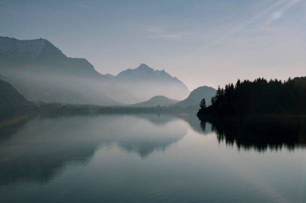 istock Tranquil mountain lake on a sunset sky background 1498959180
