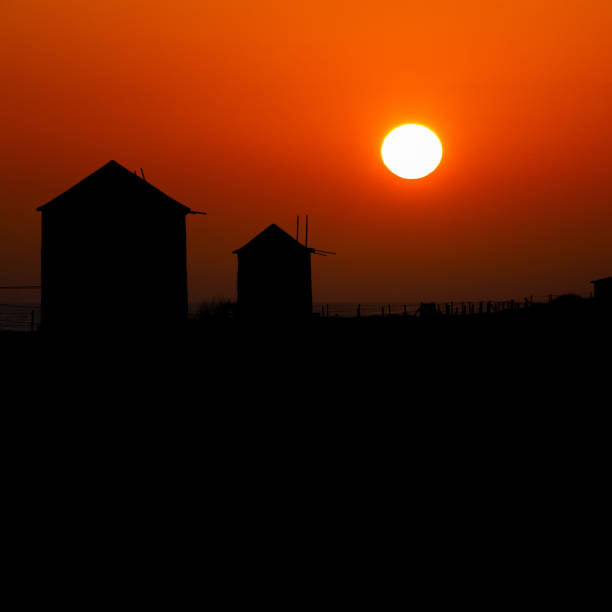 Ancient Windmills Silhouette in Apulia Beach during Sunset, Braga, Portugal.
