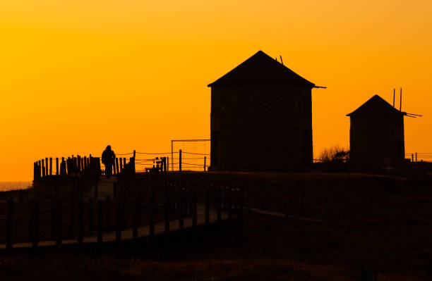 Ancient Windmills Silhouette in Apulia Beach during Sunset, Braga, Portugal.
