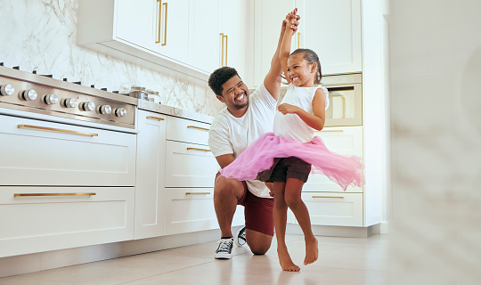 Kitchen, girl and ballet dance of a child with a dad at home dancing together and bonding. Family, father and kid dancer having fun and spending quality time with care happy from a crazy twirl