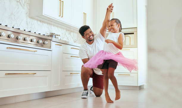 Dad, girl and ballet dance of a child in a home kitchen dancing together and bonding. Family man, father and kid dancer having fun and spending quality time with care happy from a crazy twirl Kitchen, girl and ballet dance of a child with a dad at home dancing together and bonding. Family, father and kid dancer having fun and spending quality time with care happy from a crazy twirl dancing dad stock pictures, royalty-free photos & images