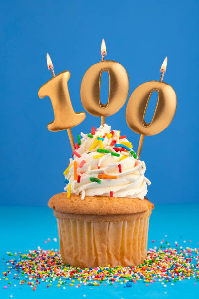istock Candle number 100 - Cake birthday in blue background 1498967048