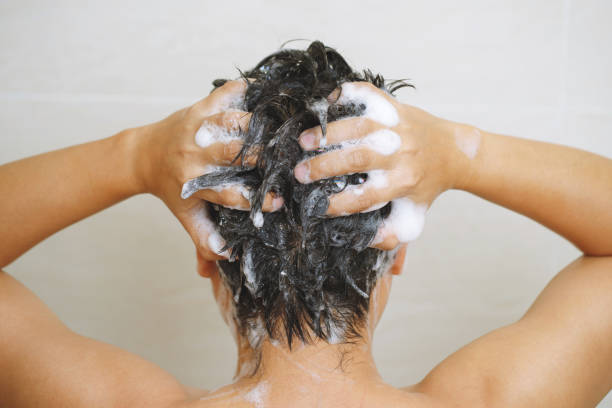 istock A man is washing his hair with shampoo 1498971558