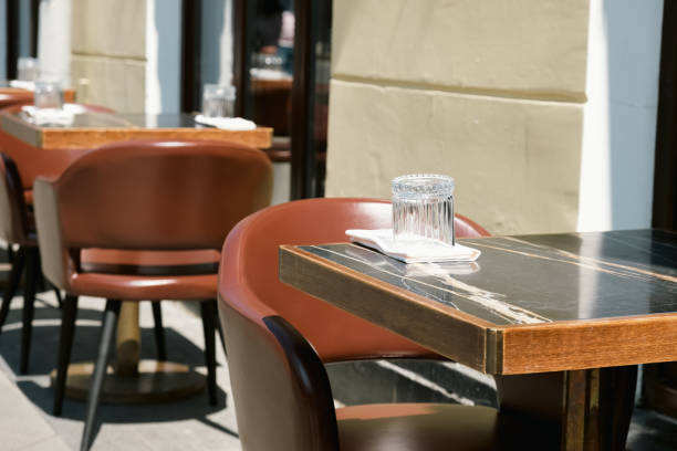 istock Empty table and chairs on the summer terrace near a small cafe 1498980248