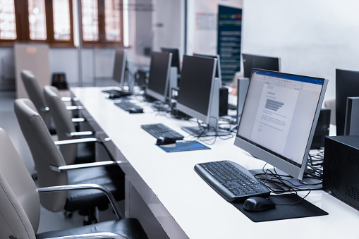 Computers on a table in an empty office