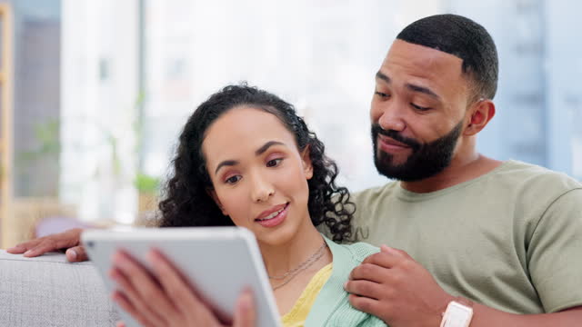 Talking, tablet and couple on home sofa together streaming or watch movies on internet. Black man and a woman conversation on couch with subscription for online shopping and mobile app or wifi choice