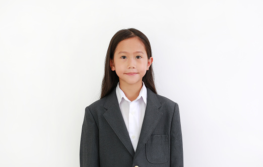 Portrait of Asian young girl child wear formalwear shirt, business suit wearing with looking at camera on white background.