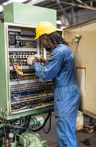 Electrical technician tests wiring, polarity, grounding, voltages and performs electrical maintenance using hand tools that involve clamp meter, screwdriver, and cutter. The foreman's routine tasks.