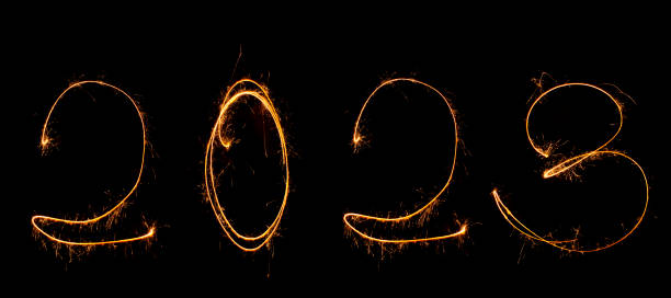 istock Year 2023 is written in numbers black background with sparklers with sparks. 1498986455