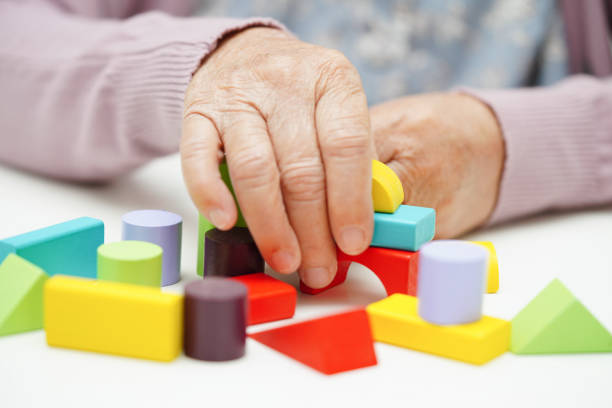 istock Asian elderly woman playing puzzles game to practice brain training for dementia prevention, Alzheimer disease. 1498986557