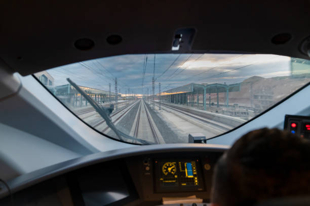 istock Motion blur view of railway from inside high speed train at evening and control panel of the locomotive just before arrive the train station 1498992175