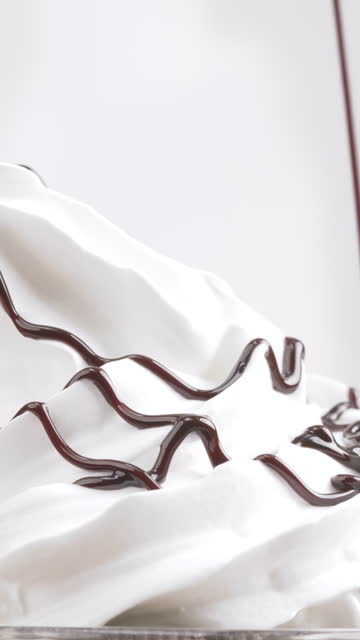 Pouring sauce Chocolate on top Whipped cream on white background.