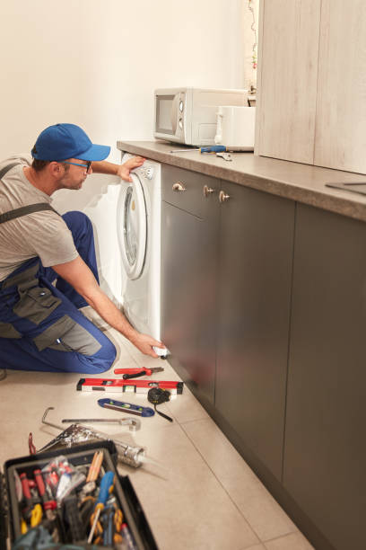 istock Handyman fixing broken washing machine in the apartment. 1498992517