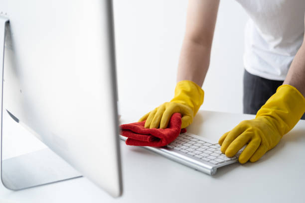 istock Close up view of man cleaning keyboard computer using clothes. Cleaning office desk concept. 1498992528