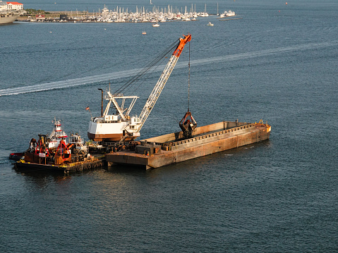 Working dredge and barge in waters of Charleston, South Carolina.