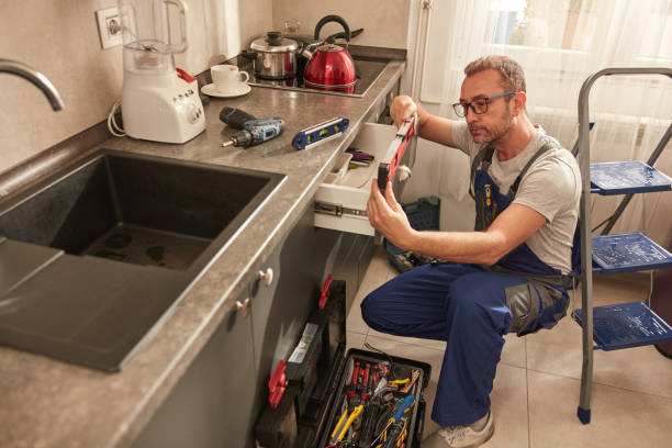 istock Handyman fixing kitchen cabinets in the apartment. 1498992728