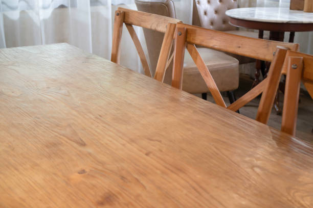 Minimalist wooden chairs bathed in natural sunlight, creating cozy modern interior scene.