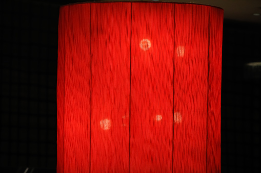 The close up of the Chinese traditional style red lantern, red lamp in the indoors.