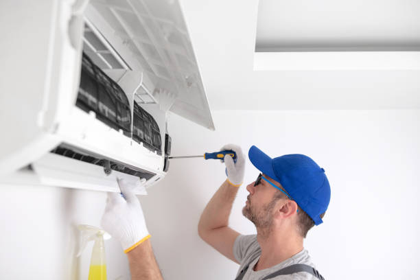 istock Service guy cleaning and maintaining air condition unit. 1498994011