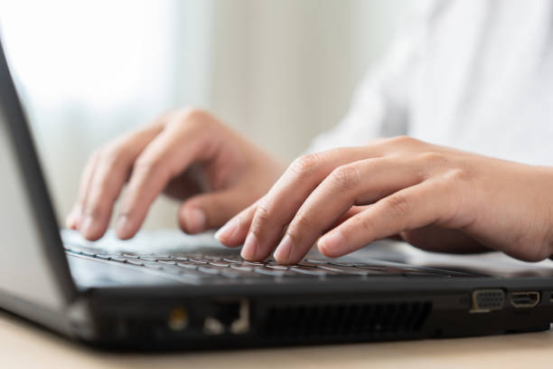 istock Woman using laptop working as typing, searching, or messaging online networking 1498995236