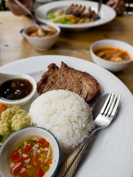 Thai rice local pork chop steak with spicy sauce and vegetables