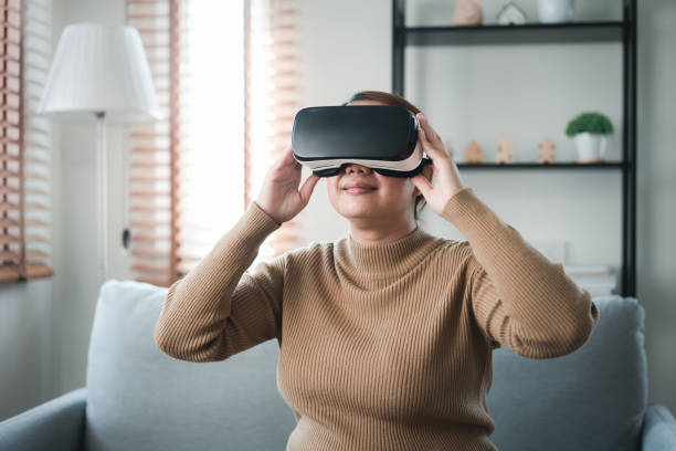 istock Asian woman enjoy using AI technology in VR glasses to explore Metaverse or online digital access. 1498995455
