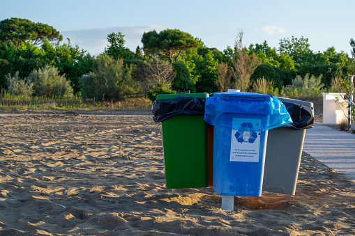 Several containers for selective waste collection on the beach
