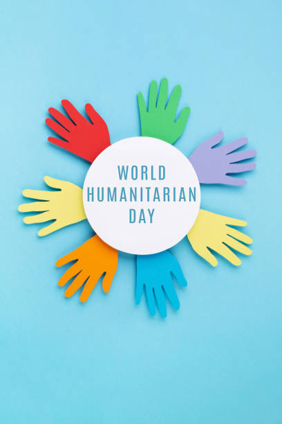 istock World Humanitarian Day Concept. Paper Hands on Blue Background. 1498997314