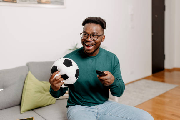 istock Man Relishes Soccer Match, Ball Within Reach 1498998609
