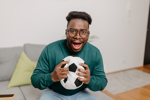 Embodying the true spirit of soccer, the young man immerses himself in the game, with his ever-present soccer ball serving as a tangible representation of his commitment and unwavering love for the sport