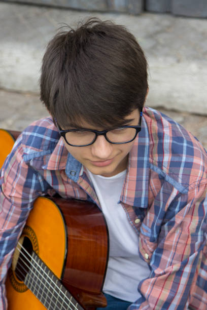 istock Man playing acoustic guitar at home 1498999545