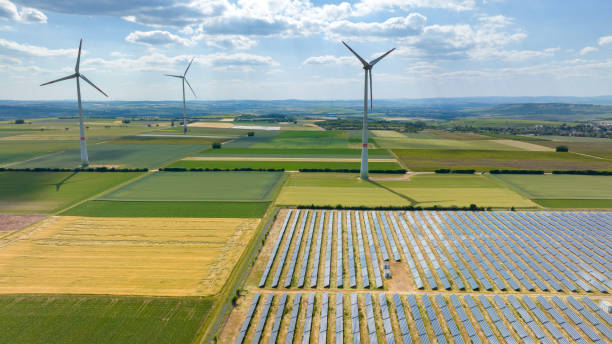 istock Wind turbines and solar park - aerial view 1499000698