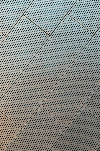 Metal Perforated Wall Tiles of contemporary building. Facade Wall. Construction, archetecture texture