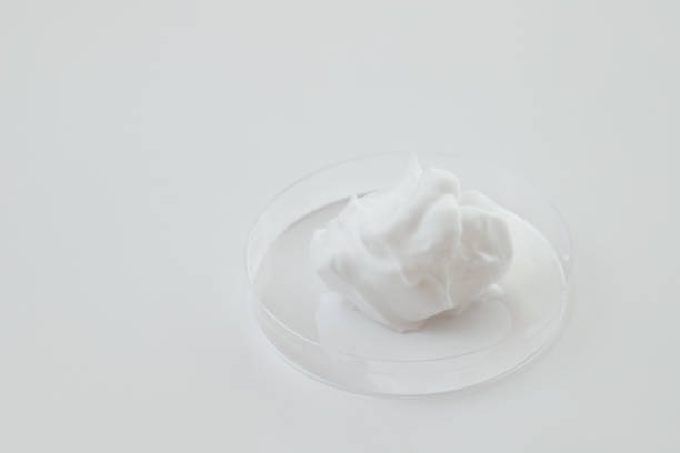 istock White Cosmetics Foam in Glass Lab Petri Dish on White background 1499002637