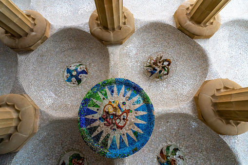 Curved bench decorated with mosaic tiles in Park Guell, Barcelona, Spain
