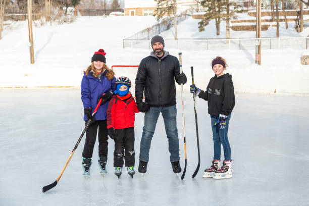 istock Father & His Three Children Ice Skating in Winter 1499004911