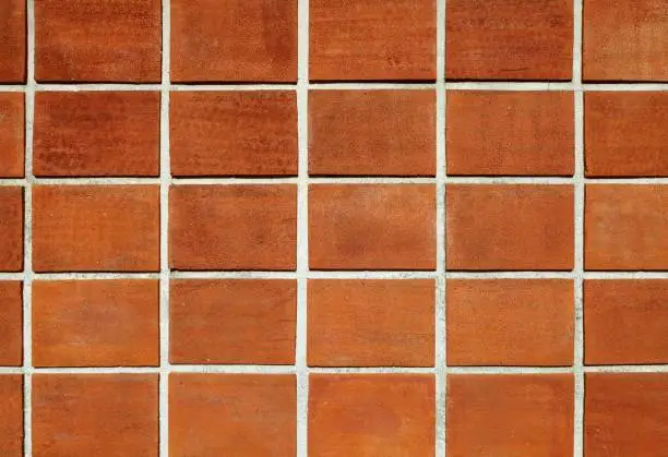 Terracotta tiled wall. Background and texture. Full frame.