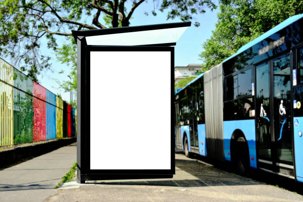 istock bus shelter and lightbox. blank white billboard ad panel at bus stop. background for mockup. blue transit bus on the side. 1499005201