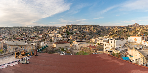 A picture of the town of Goreme and the landscape of the Goreme Historical National Park, in Cappadocia, as seen from the roof of a hotel.