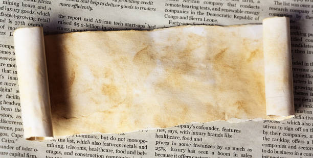 istock Old stained scroll with blank space for your copy, on a modern newspaper 1499006107