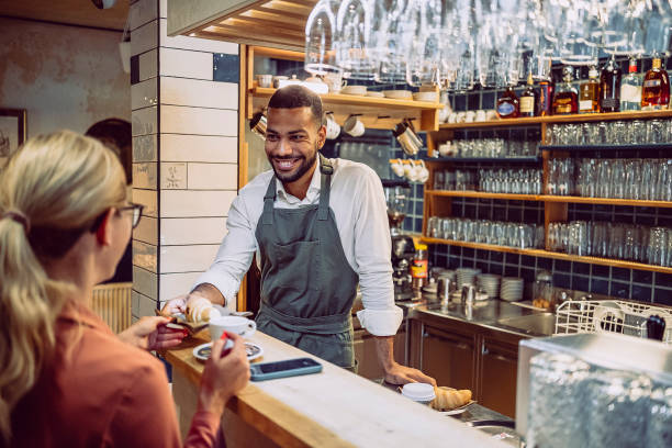 istock Customer of a coffee bar is being served by the waiter 1499008421