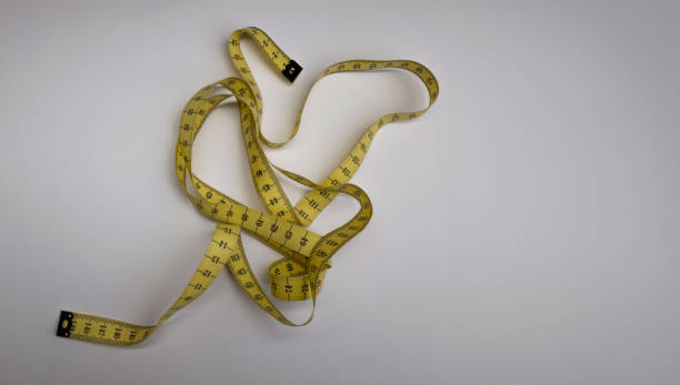 istock Measuring tape for slimming diet on white background 1499014636
