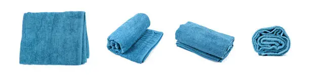 Rolled Blue Towel Isolated. New Terry Cotton Towel, Soft Washcloth on White Background