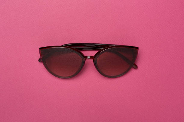 istock Sunglasses on color background, top view. 1499016450