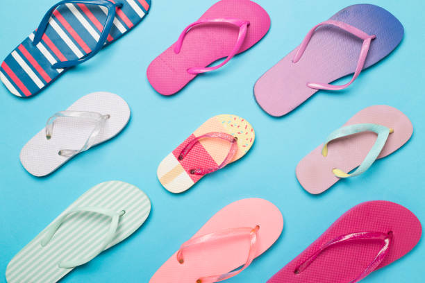 istock Many bright flip flops on color background, top view 1499016455