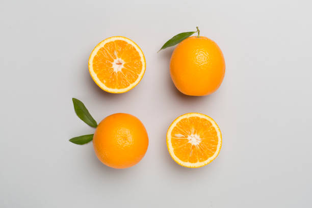 istock Flat lay with fresh oranges and leaves on color background 1499016727