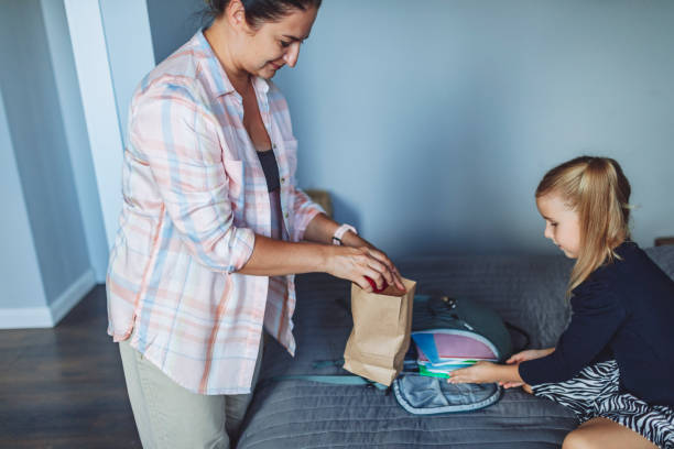 istock Mother helping her daughter packing things for school 1499018137