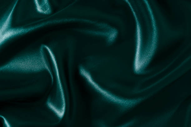 istock Silk fabric, abstract wavy green satin fabric background. 1499018897