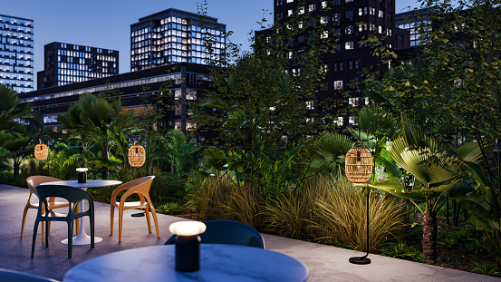 A lush garden on the rooftop of an office or apartment building at night