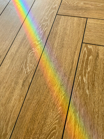 High angle view of a prism light effect on wooden floor